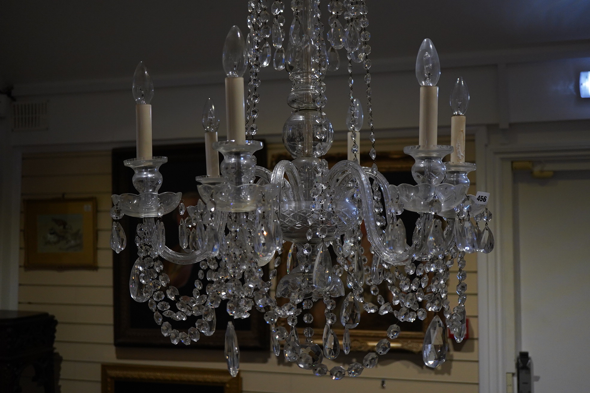 A cut glass five branch chandelier with drops